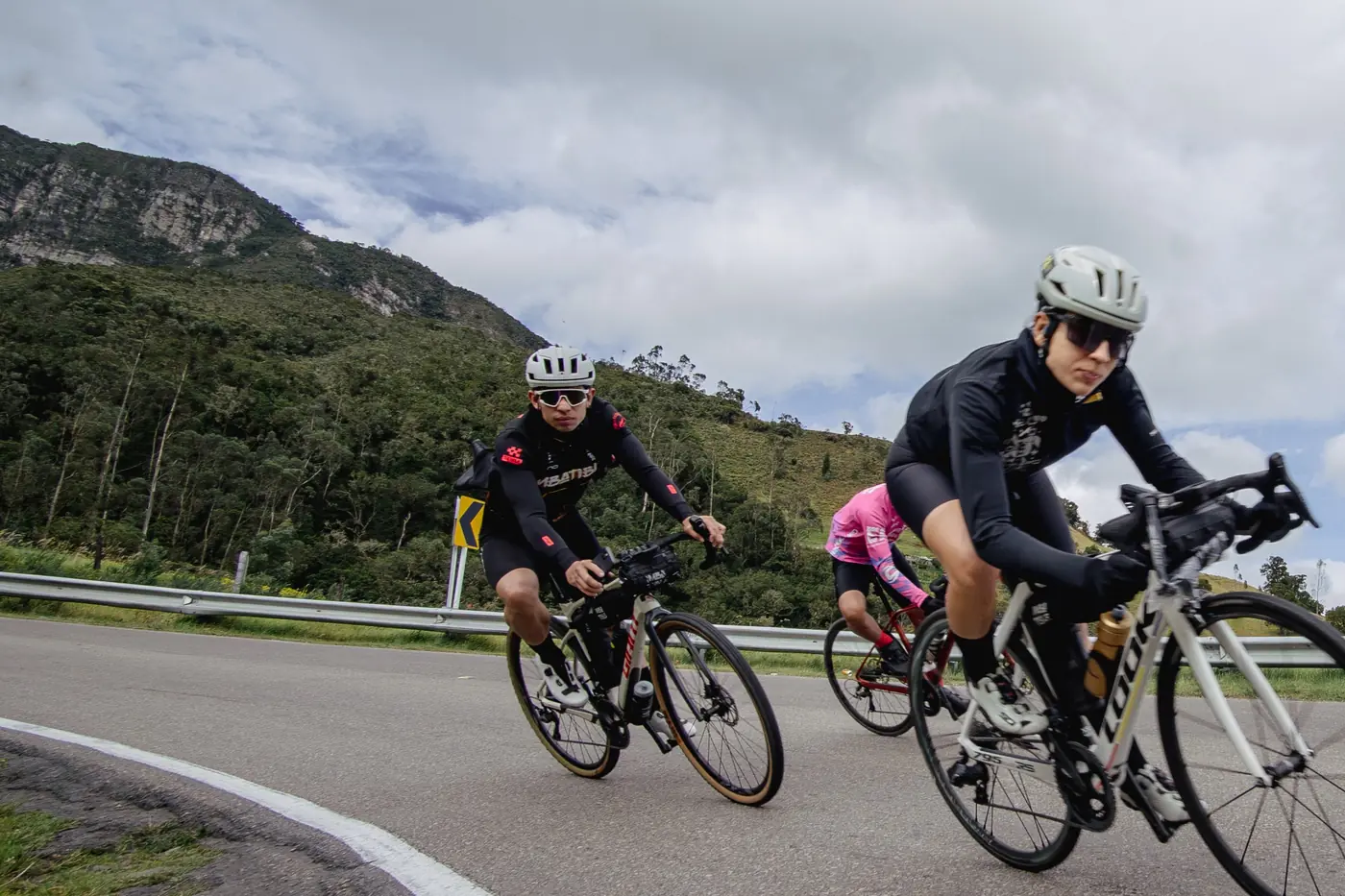Ciclistas en el ascenso con las montañas de Tabio al fondo
